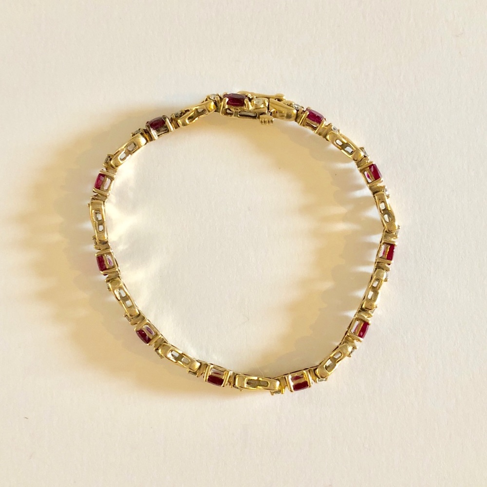 Gold cross-link bracelet w/ diamond + garnet inlay